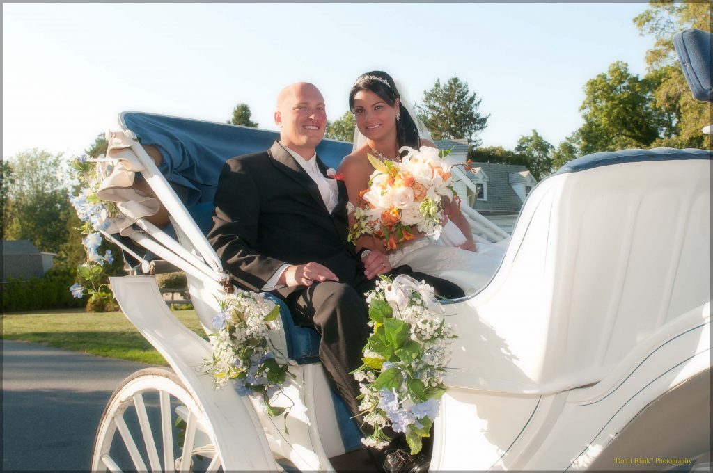 Bride and groom in the back of a carriage